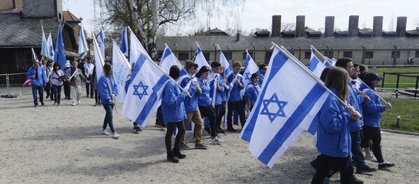 People take part in the annual March of the Living to commemorate the Holocaust, a yearly Holocaust remembrance march between the former death camps of Auschwitz and Birkenau, in Oswiecim, Poland People take part in the annual March of the Living to commemorate the Holocaust, a yearly Holocaust remembrance march between the former death camps of Auschwitz and Birkenau, in Oswiecim, Poland - Sputnik International