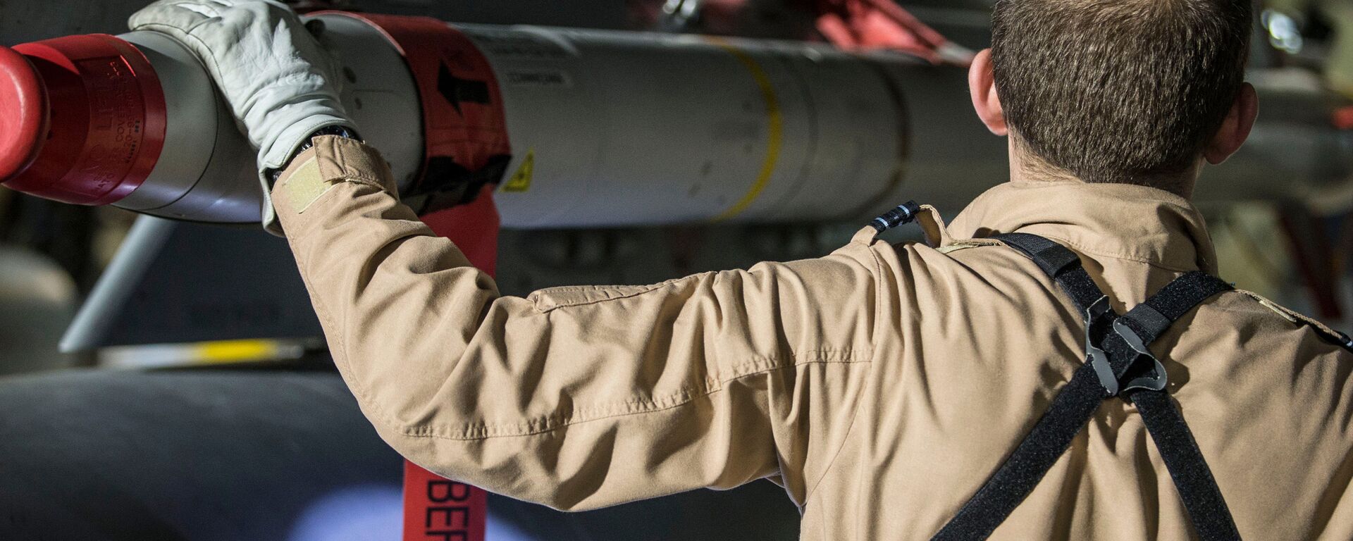 In this image released by Britain's Ministry of Defense, a Tornado pilot checks the weapons on his Tornado at Britain Royal Air Force base in Akrotiri, Cyprus, after its mission to conduct strikes in support of operations over the Middle East Saturday, April 14, 2018 - Sputnik International, 1920, 19.08.2021