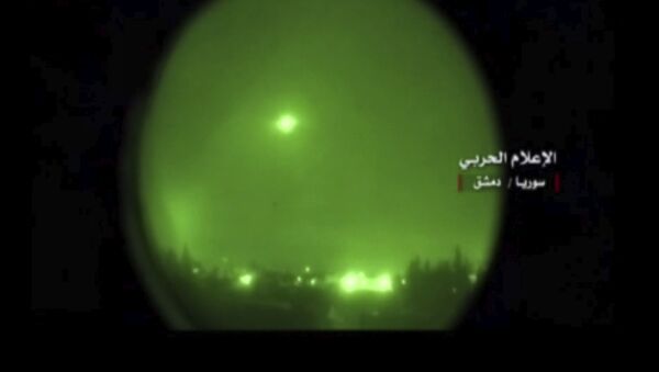 This frame grab from video provided by the government-controlled Syrian Central Military Media, shows missile flying over the capital Damascus during airstrikes by the United States, France and Britain, in Syria, Saturday, April 14, 2018 - Sputnik International