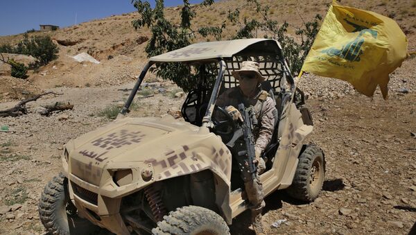 A Hezbollah fighters sits in a four-wheel motorcycle positioned at the site where clashes erupted between Hezbollah and al-Qaida-linked fighters in Wadi al-Kheil or al-Kheil Valley in the Lebanon-Syria border, Saturday, July 29, 2017 - Sputnik International