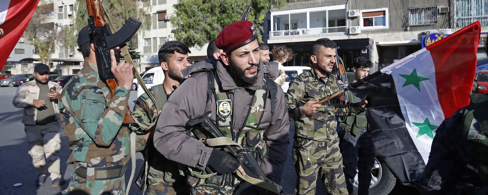 Syrian soldier wave weapons and national flags as they chant slogans against U.S. President Trump during demonstrations following a wave of U.S., British and French military strikes to punish President Bashar Assad for suspected chemical attack against civilians, in Damascus, Syria, Saturday, April 14, 2018 - Sputnik International, 1920, 30.10.2020