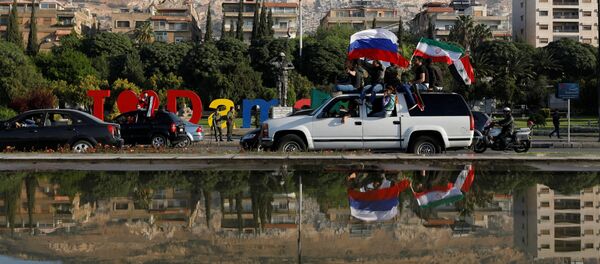 Syrian government supporters chant slogans against US President Donald Trump during demonstrations following US, British and French missile strikes on Syria, April 14, 2018 - Sputnik International