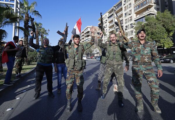 Syrian government supporters chant slogans against U.S. President Trump during demonstrations following a wave of U.S., British and French military strikes to punish President Bashar Assad for suspected chemical attack against civilians, in Damascus, Syria, Saturday, April 14, 2018 Syrian government supporters chant slogans against U.S. President Trump during demonstrations following a wave of U.S., British and French military strikes to punish President Bashar Assad for suspected chemical attack against civilians, in Damascus, Syria, Saturday, April 14, 2018 - Sputnik International