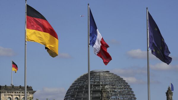 The French, center, the German, left, and the EU flag, right, fly in front of the German parliament (File) - Sputnik International