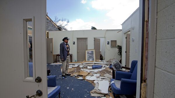Pastor Lester Woodard surveys the damage inside Living Hope Missionary Baptist Church, Monday, April 16, 2018, in Greensboro, N.C. Sunday's tornado destroyed most of the roof and furniture in the church.  - Sputnik International