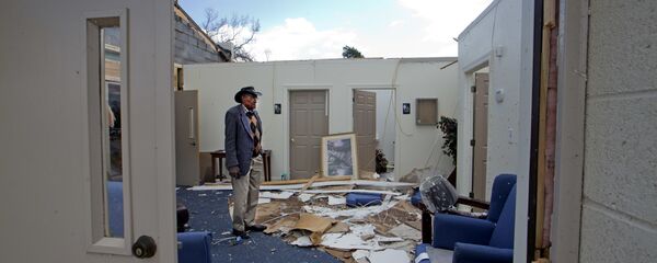 Pastor Lester Woodard surveys the damage inside Living Hope Missionary Baptist Church, Monday, April 16, 2018, in Greensboro, N.C. Sunday's tornado destroyed most of the roof and furniture in the church.  - Sputnik International