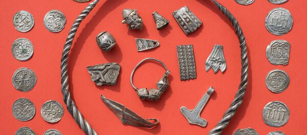 Parts of the silver treasure are pictured on a table in Schaprode, northern Germany on April 13, 2018. A 13-year-old boy and a hobby archaeologist have unearthed a significant trove in Germany which may have belonged to the legendary Danish king Harald Bluetooth who brought Christianity to Denmark Parts of the silver treasure are pictured on a table in Schaprode, northern Germany on April 13, 2018. A 13-year-old boy and a hobby archaeologist have unearthed a significant trove in Germany which may have belonged to the legendary Danish king Harald Bluetooth who brought Christianity to Denmark - Sputnik International