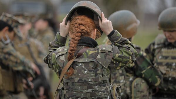 A Romanian female soldier adjusts her helmet before taking part in weapons training with US Marines female counterparts at the Capu Midia Surface to Air Firing Range, on the Black Sea coast in Romania, Monday, March 20, 2017 - Sputnik International