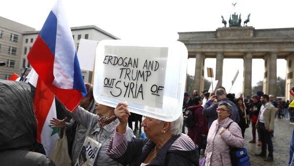 (File) A protester holds a poster during the demonstration against airstrikes on Syria in Berlin, Germany April 14, 2018 - Sputnik International
