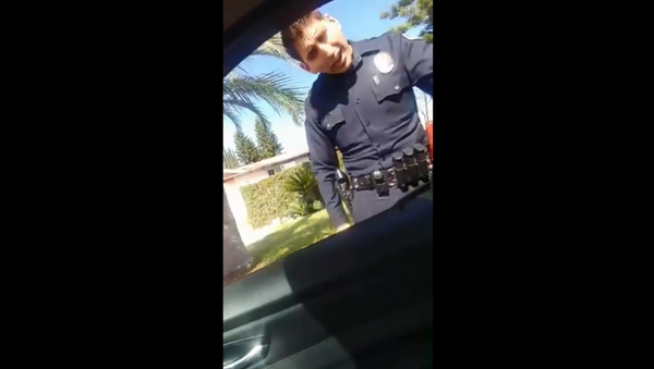 California’s West Covina Police Department landed in hot water after an officer was recorded snatching a woman's phone during a traffic stop. - Sputnik International