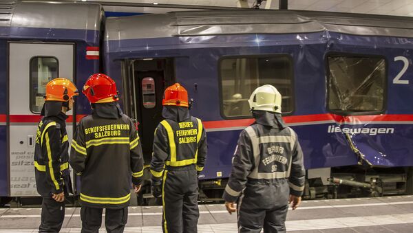 Fire fighters stand in front of two trains collided in the Salzburg, Austria, main station early Friday, April 20, 2018 - Sputnik International