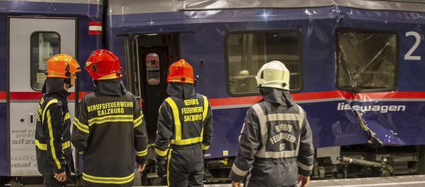 Fire fighters stand in front of two trains collided in the Salzburg, Austria, main station early Friday, April 20, 2018 - Sputnik International