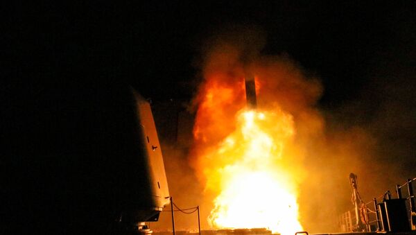 The U.S. Navy guided-missile cruiser USS Monterey fires a Tomahawk land attack missile April 14, 2018 - Sputnik International
