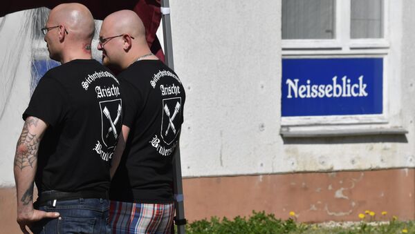 Private security personel with Aryan Brotherhood on their T-shirts stand guard at the venue of the Schild und Schwert (Shield and Sword) neo-nazi festival, in the small eastern German town of Ostritz - Sputnik International