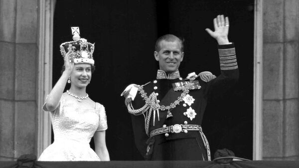 This is a June. 2, 1953 file photo of Britain's Queen Elizabeth II and Prince Philip, Duke of Edinburgh, as they wave to supporters from the balcony at Buckingham Palace, following her coronation at Westminster Abbey. London - Sputnik International