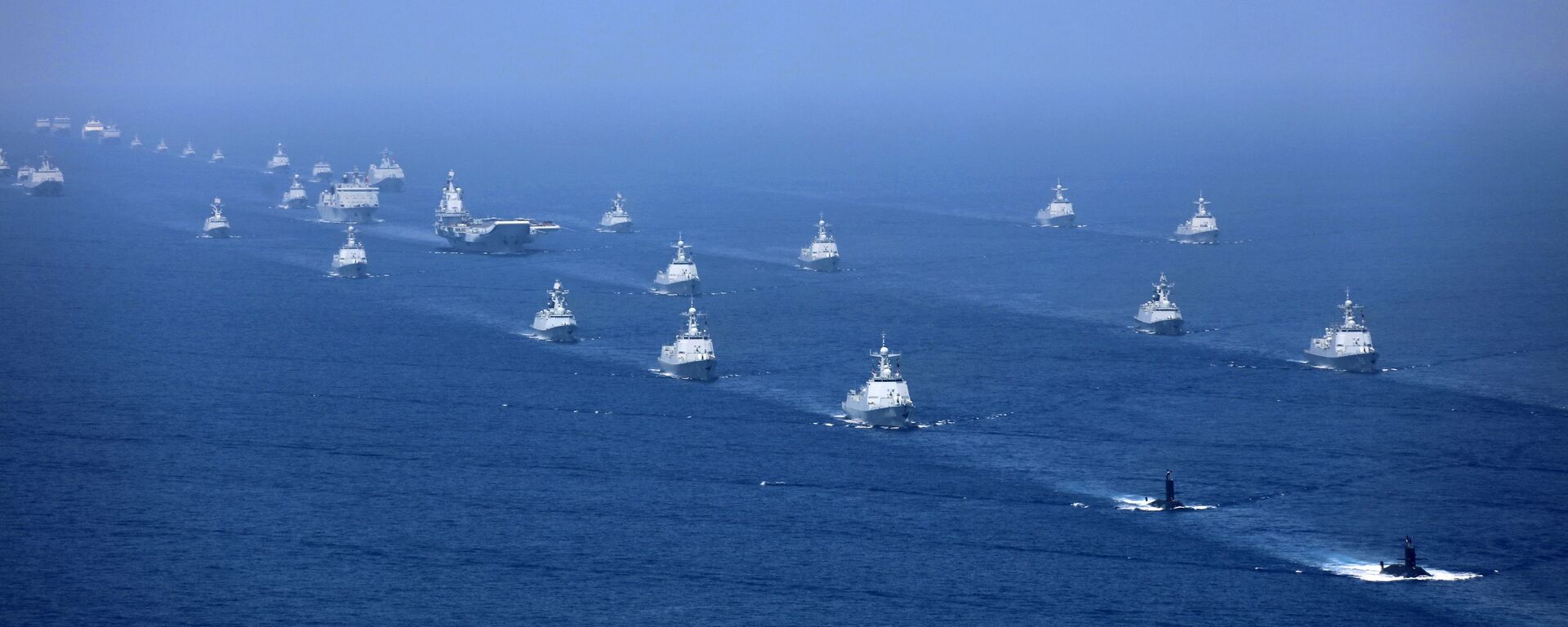 In this April 12, 2018 photo released by Xinhua News Agency, the Liaoning aircraft carrier is accompanied by navy frigates and submarines conducting an exercises in the South China Sea - Sputnik International, 1920, 04.08.2022