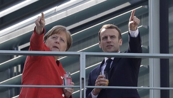 French President Emmanuel Macron, right, and German Chancellor Angela Merkel take a break on a balcony of Merkel's office after a meeting in the chancellery in Berlin, Germany, Thursday, April 19, 2018 - Sputnik International
