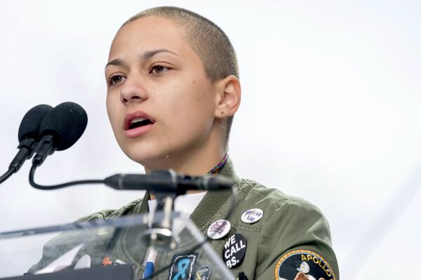 In this March 24, 2018 file photo, Emma Gonzalez, a survivor of the mass shooting at Marjory Stoneman Douglas High School in Parkland, Fla., closes her eyes and cries as she stands silently at the podium for the amount of time it took the Parkland shooter to go on his killing spree during the March for Our Lives rally in support of gun control in Washington. A doctored photo online appeared to show Gonzalez tearing up the U.S. Constitution. , Saturday, March 24, 2018 - Sputnik International