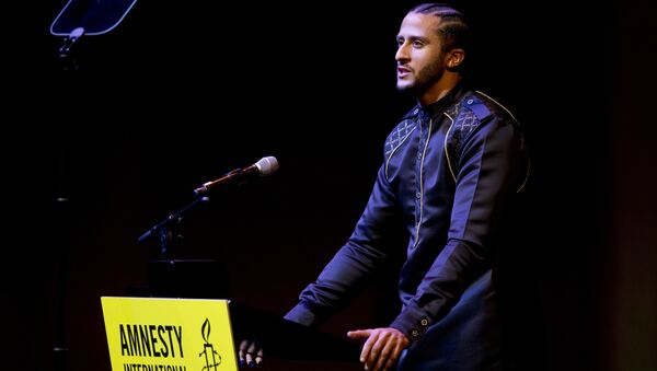 Former NFL quarterback and social justice activist Colin Kaepernick speaks after receiving the Amnesty International Ambassador of Conscience Award for 2018 in Amsterdam, Saturday April 21, 2018. Kaepernick became a controversial figure when refusing to stand for the national anthem, instead he knelt to protest racial inequality and police brutality. - Sputnik International