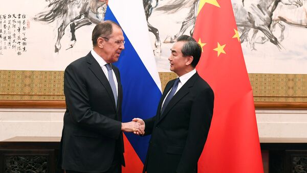 Russian Foreign Minister Sergei Lavrov shakes hands with Chinese State Councilor and Foreign Minister Wang Yi at the Diaoyutai State Guest House in Beijing, China, April 23, 2018 - Sputnik International