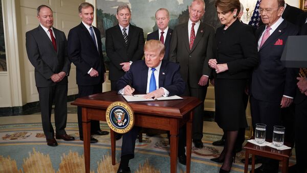 US President Donald Trump signs trade sanctions against China on March 22, 2018, in the Diplomatic Reception Room of the White House in Washington, DC, on March 22, 2018. Trump will impose tariffs on about $50 billion in Chinese goods imports to retaliate against the alleged theft of American intellectual property, White House officials said Thursday - Sputnik International