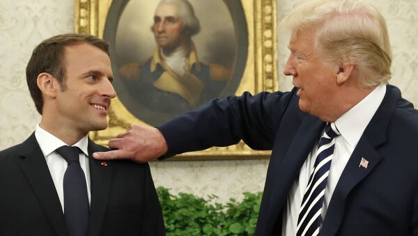 French President Emmanuel Macron (L) looks on as U.S. President Donald Trump flicks a bit of lint off his jacket during their meeting in the Oval Office following the official arrival ceremony for Macron at the White House in Washington, U.S., April 24, 2018. - Sputnik International