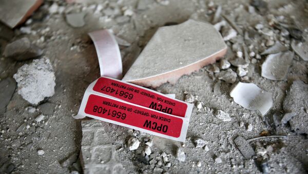 Labels of the Organisation for the Prohibition of Chemical Weapons (OPCW) are seen iside a damaged house in Douma in Damascus, Syria April 23, 2018 - Sputnik International
