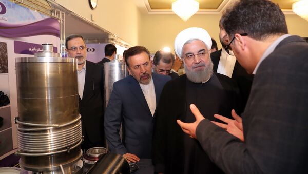 President Hassan Rouhani listens to explanations on new nuclear achievements at a ceremony to mark National Nuclear Day, in Tehran, Iran, Monday, April 9, 2018 - Sputnik International