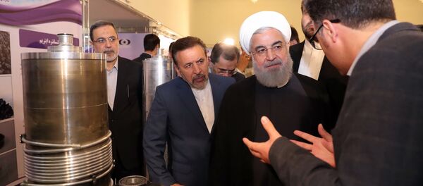 President Hassan Rouhani listens to explanations on new nuclear achievements at a ceremony to mark National Nuclear Day, in Tehran, Iran, Monday, April 9, 2018 - Sputnik International