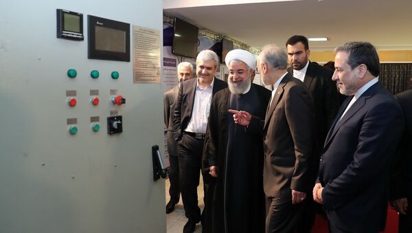 President Hassan Rouhani listens to explanations on new nuclear achievements at a ceremony to mark National Nuclear Day, in Tehran, Iran, Monday, April 9, 2018 - Sputnik International