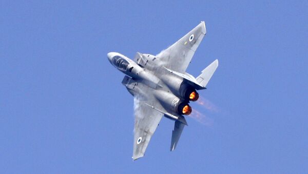 An Israeli F-15 fighter jet performs a rehearsal ahead of an air show to commemorate the 70th anniversary of the creation of Israel in May, in the coastal city of Tel Aviv on April 12, 2018 - Sputnik International