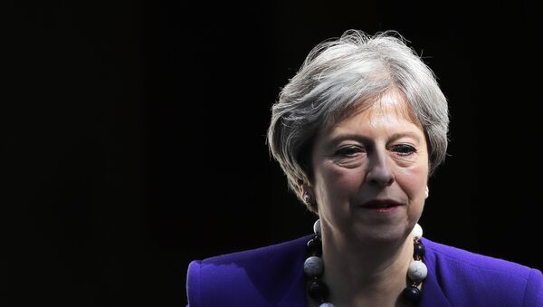 Britain's Prime Minister Theresa May leaves 10 Downing Street in central London on April 18, 2018, as she heads to the weekly Prime Minister's Questions (PMQs) session in the House of Commons. - Sputnik International