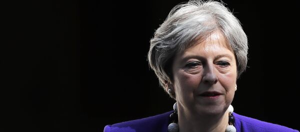 Britain's Prime Minister Theresa May leaves 10 Downing Street in central London on April 18, 2018, as she heads to the weekly Prime Minister's Questions (PMQs) session in the House of Commons. - Sputnik International