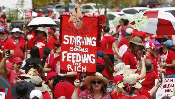 Thousands participate in a protest at the Arizona Capitol for higher teacher pay and school funding on the first day of a state-wide teachers strike Thursday, April 26, 2018, in Phoenix. - Sputnik International