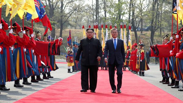 South Korean President Moon Jae-in walks with North Korean leader Kim Jong Un at the truce village of Panmunjom inside the demilitarized zone separating the two Koreas, South Korea, April 27, 2018 - Sputnik International