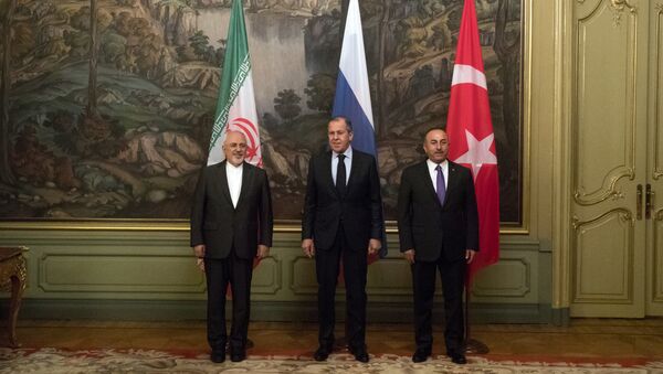 Russian Foreign Minister Sergey Lavrov, center, Turkey's Foreign Minister Mevlut Cavusoglu, right, and Iranian Foreign Minister Mohammad Javad Zarif pose for a photographers during their meeting in Moscow, Russia, Saturday, April 28, 2018 - Sputnik International