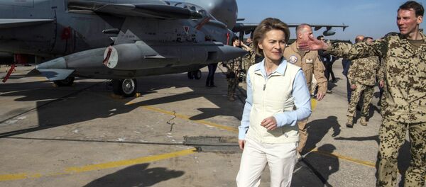 German Defence Minister Ursula von der Leyen, left, inspects a German air force aircraft as she visits the German contingent at the Al Azraq air base in Jordan. File photo - Sputnik International
