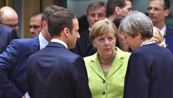 French President Emmanuel Macron, second left, speaks with German Chancellor Angela Merkel, center, and British Prime Minister Theresa May, right, during a round table meeting at an EU summit in Brussels on Thursday, June 22, 2017 - Sputnik International