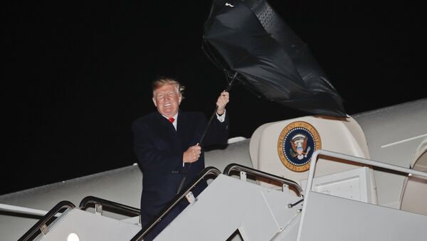 U.S. President Donald Trump's umbrella is turned inside out by a gust of wind while stepping off Air Force One during his arrival at Andrews Air Force Base, Md., Saturday, April 28, 2018 - Sputnik International