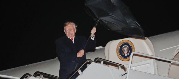 U.S. President Donald Trump's umbrella is turned inside out by a gust of wind while stepping off Air Force One during his arrival at Andrews Air Force Base, Md., Saturday, April 28, 2018 U.S. President Donald Trump's umbrella is turned inside out by a gust of wind while stepping off Air Force One during his arrival at Andrews Air Force Base, Md., Saturday, April 28, 2018 - Sputnik International