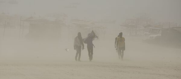 Indians walk on the banks of the river Ganges during a dust storm in Allahabad, India (File) - Sputnik International