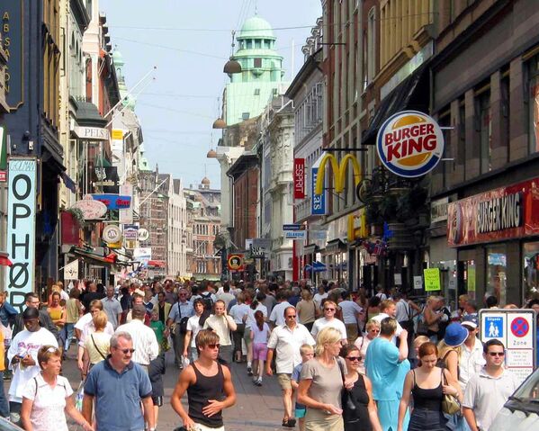 Tourists visiting main pedestrian street in Copenhagen called Stroget. It is one of Europe's longest pedestrian streets with a wealth of shops, from budget-friendly chains to some of the world's most expensive brands - Sputnik International