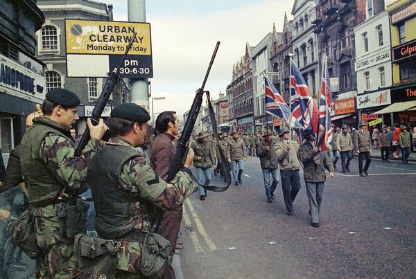 Under the watchful eyes of armed British troops, members of the Ulster Defence Association parade through Belfast, Northern Ireland in August 1972 Under the watchful eyes of armed British troops, members of the Ulster Defence Association parade through Belfast, Northern Ireland in August 1972 - Sputnik International