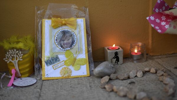Picture shows candles and a photograph of Maddie, placed on the street as a tribute to Madeleine McCann, outside the church in Praia da Luz near Lagos on May 3, 2017 - Sputnik International