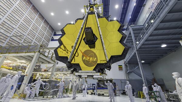 In this April 13, 2017 photo provided by NASA, technicians lift the mirror of the James Webb Space Telescope using a crane at the Goddard Space Flight Center in Greenbelt, Md. - Sputnik International