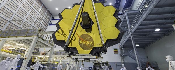 In this April 13, 2017 photo provided by NASA, technicians lift the mirror of the James Webb Space Telescope using a crane at the Goddard Space Flight Center in Greenbelt, Md. In this April 13, 2017 photo provided by NASA, technicians lift the mirror of the James Webb Space Telescope using a crane at the Goddard Space Flight Center in Greenbelt, Md. - Sputnik International