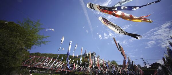 Colorful carp streamers flutter in the air over the Kawakami Gorge in Saga, Saga prefecture, southwestern Japan, Friday, April 13, 2018. The colorful streamers are hung to mark Children's Day on May 5, wishing children's healthy growth like carp that can swim up a waterfall Colorful carp streamers flutter in the air over the Kawakami Gorge in Saga, Saga prefecture, southwestern Japan, Friday, April 13, 2018. The colorful streamers are hung to mark Children's Day on May 5, wishing children's healthy growth like carp that can swim up a waterfall - Sputnik International
