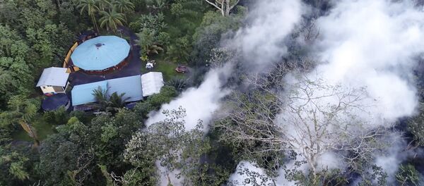 In this still frame taken from video, lava flows toward a home in the Puna District as a result of the eruption from Kilauea Volcano on Hawaii's Big Island, Friday, May 4, 2018 - Sputnik International
