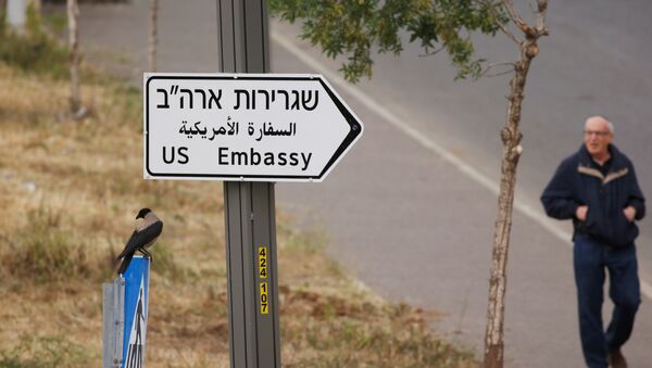 A man walks next to a road sign directing to the U.S. embassy, in the area of the U.S. consulate in Jerusalem, May 7, 2018 - Sputnik International