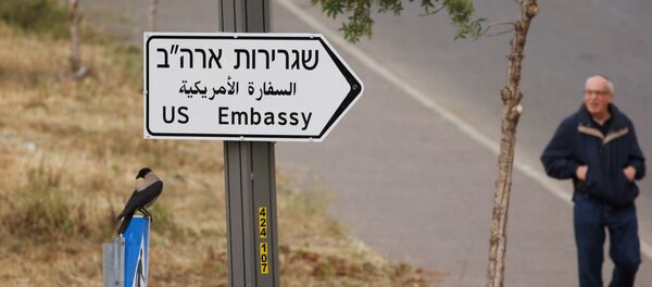 A man walks next to a road sign directing to the U.S. embassy, in the area of the U.S. consulate in Jerusalem, May 7, 2018 - Sputnik International